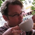 Photo of Mark Reid drinking a coffee